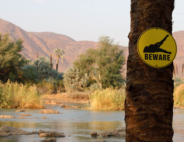 beware of crocodiles, camp cornie am kunene, namibia